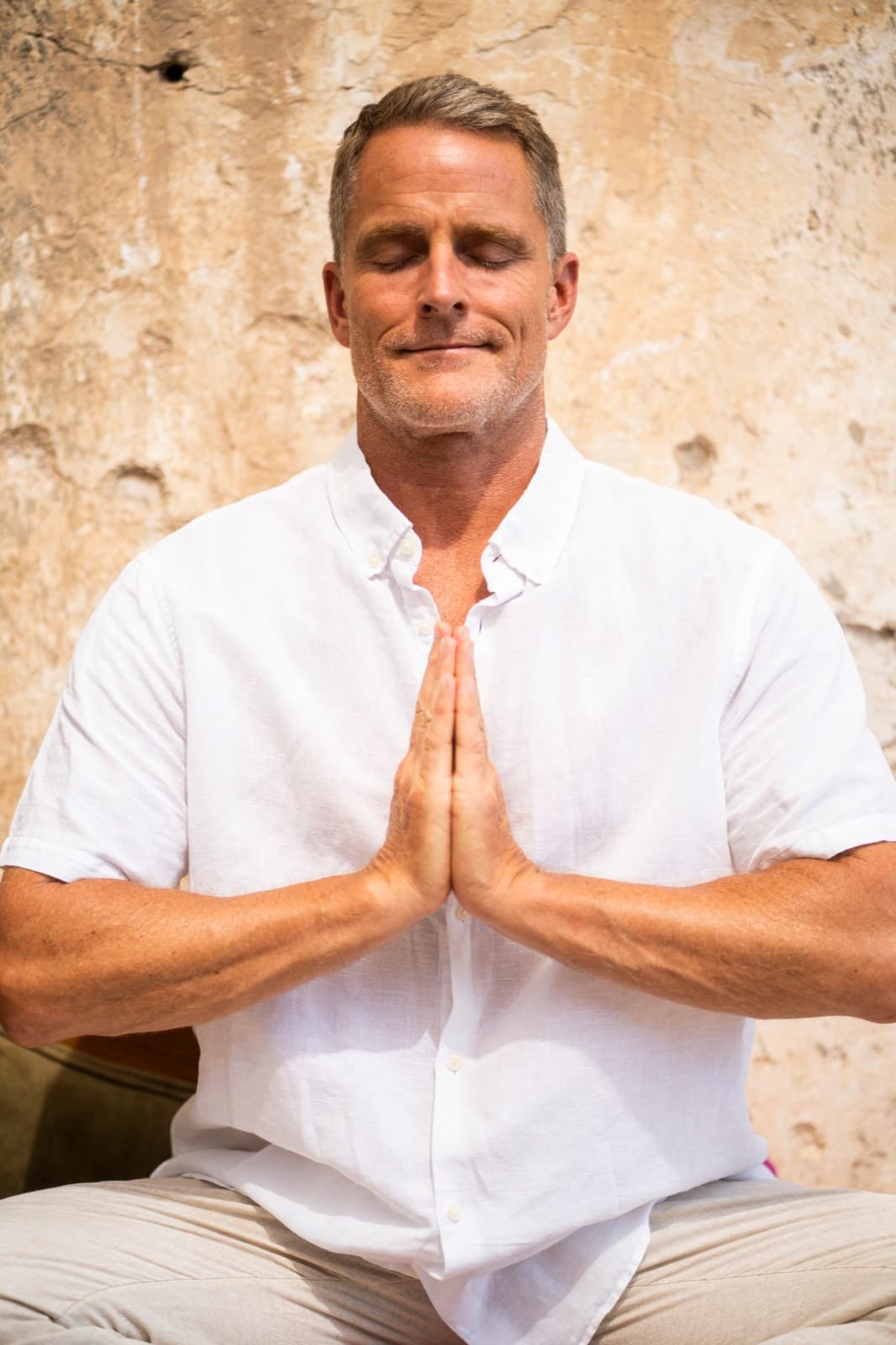 Jason Milne in seated prayer pose