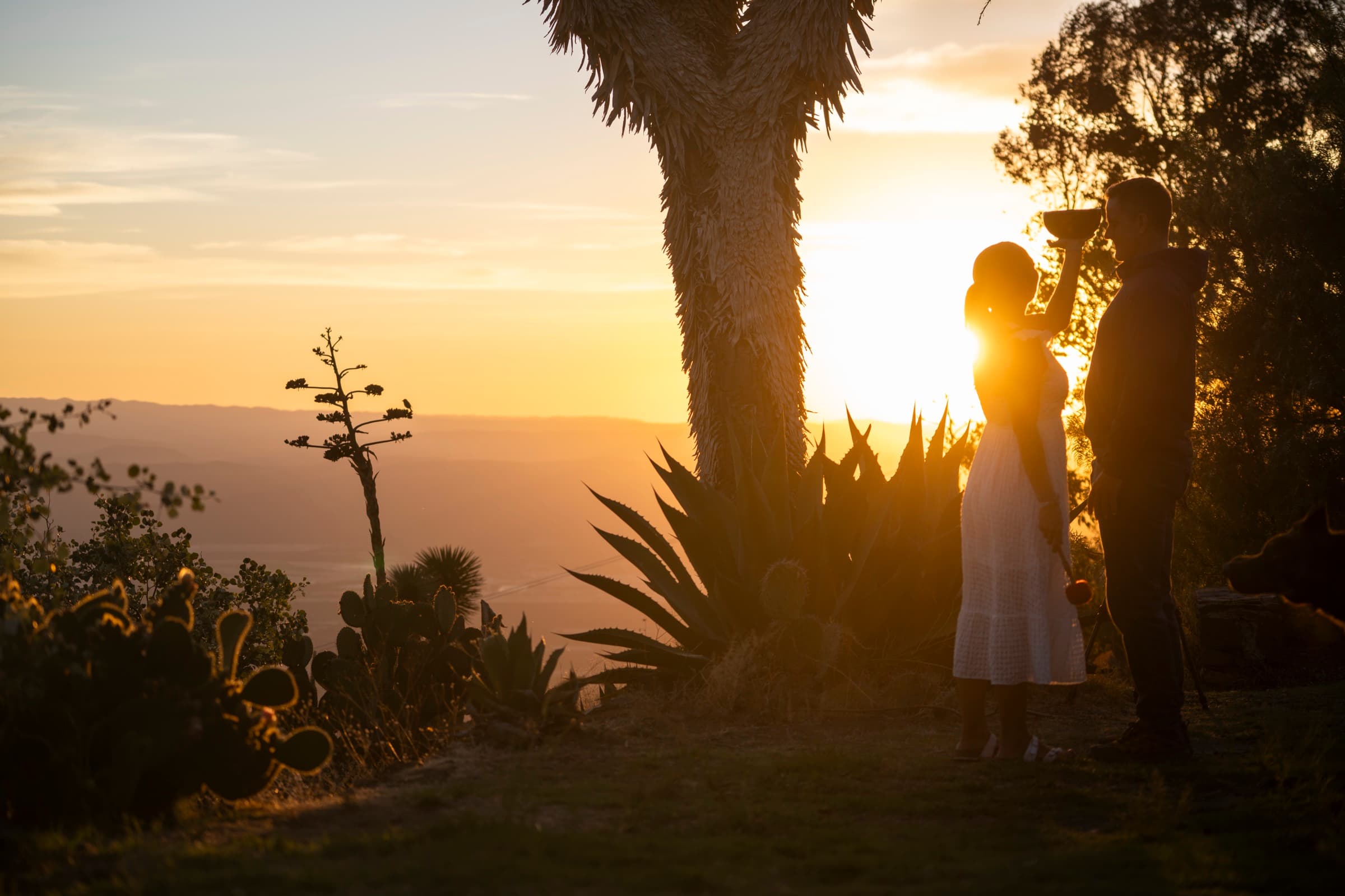 A couple in sacred ceremony at sunset