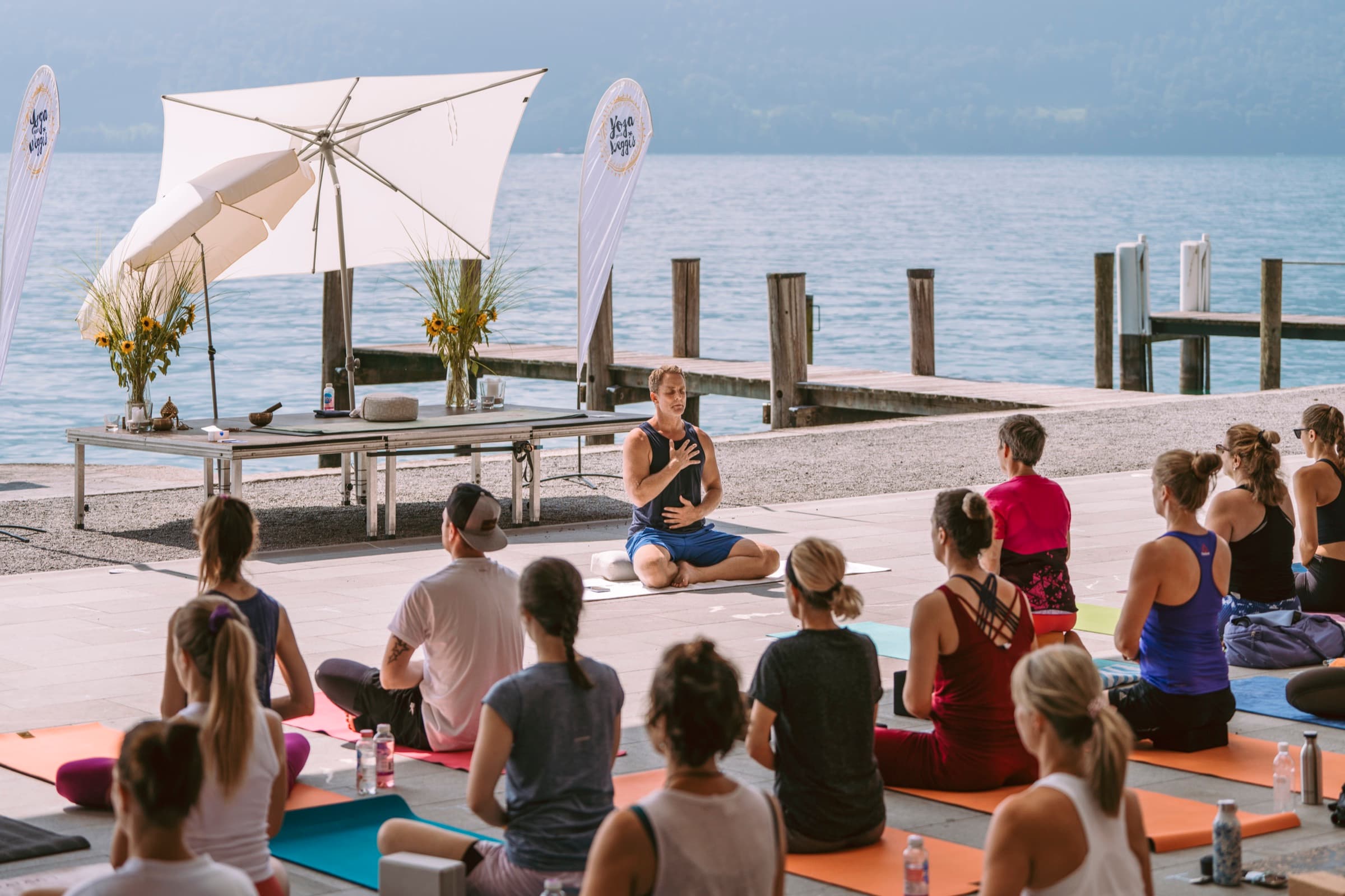 Jason Milne leading a lakeside yoga class
